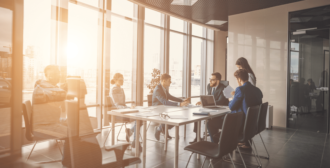 Business people discussing a private markets deal in a meeting